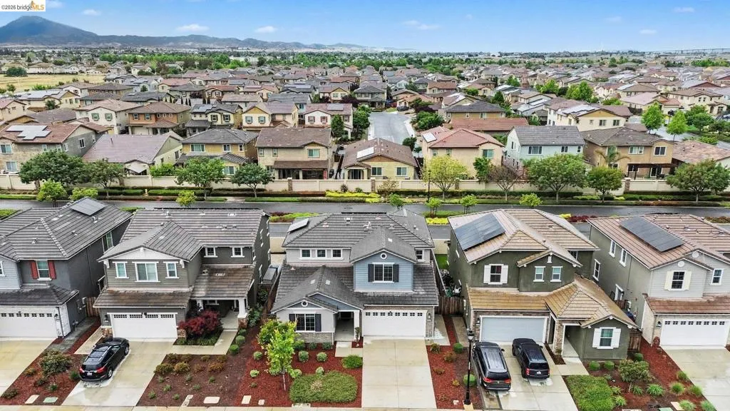 Suburban residential streetscape with a mountain backdrop