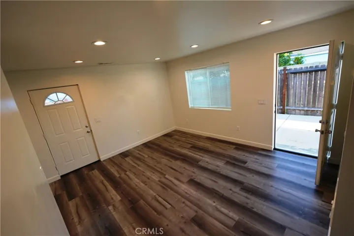 Notice the LED lights, laminate flooring and spacious living room area