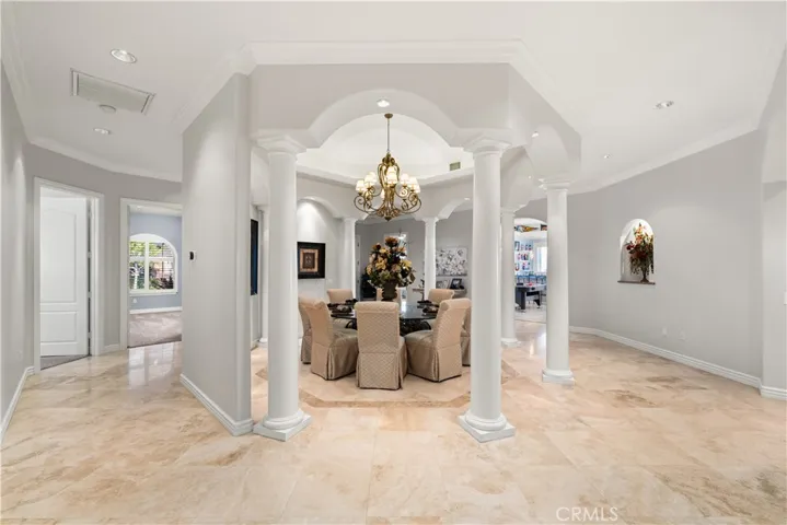 Focal Point of the Home is the Dining Area with a Coffered Ceiling and Statement Lighting.