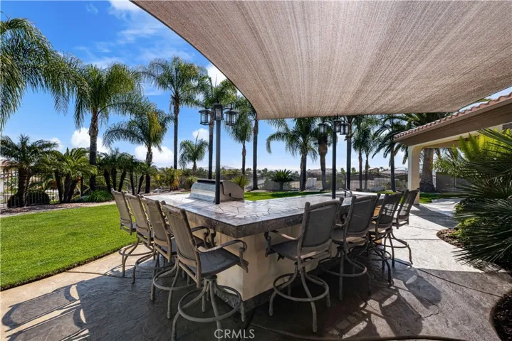 Outdoor Island with an Abundance of Seating and a Sun Shade.