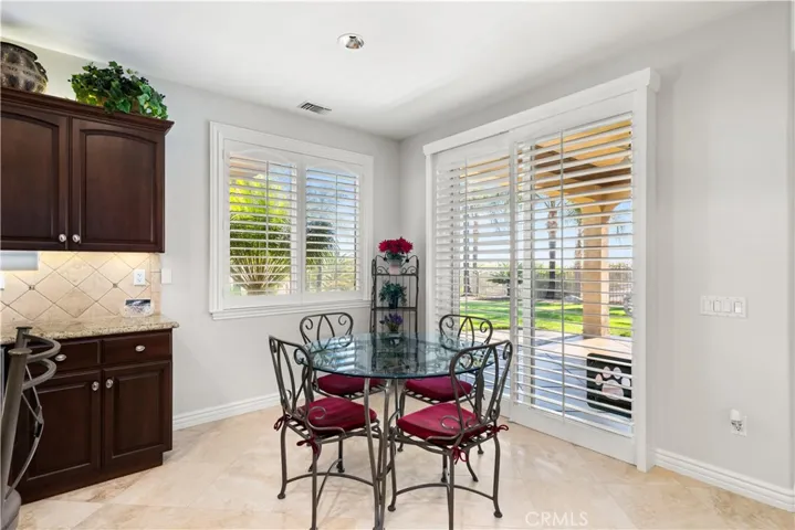 Eating Area in the Kitchen with Shutters and Sliding Door to the Backyard
