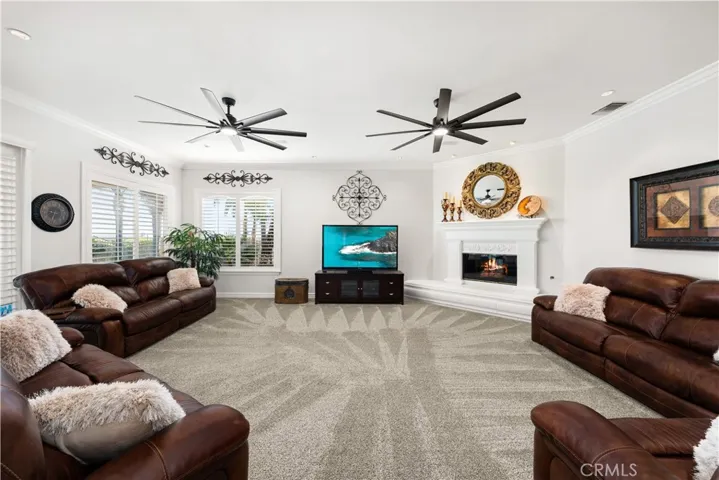 Family Room with a High Hearth, Mantle and Gas Fireplace.  There are also Shutters and Sliding Door to Backyard.