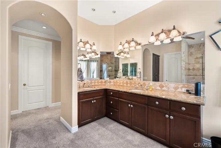 Primary Bathroom with Dual Sinks and Cabinet Storage