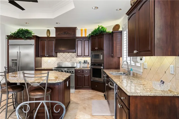 KitchenAid Appliances: Built-In Refrigerator, Cooktop/Oven, Another Single Oven, Microwave, Trash Compactor and Dish Washer