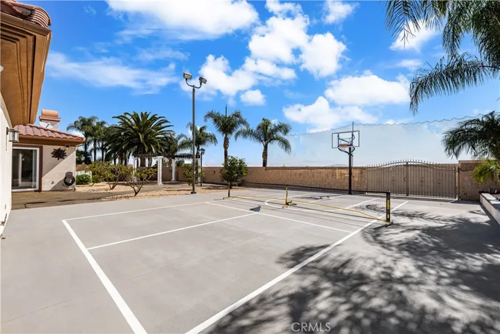 Pickleball Court and Half Basketball Court with Discreet Netting Behind the Wall to Keep the Playing Going.