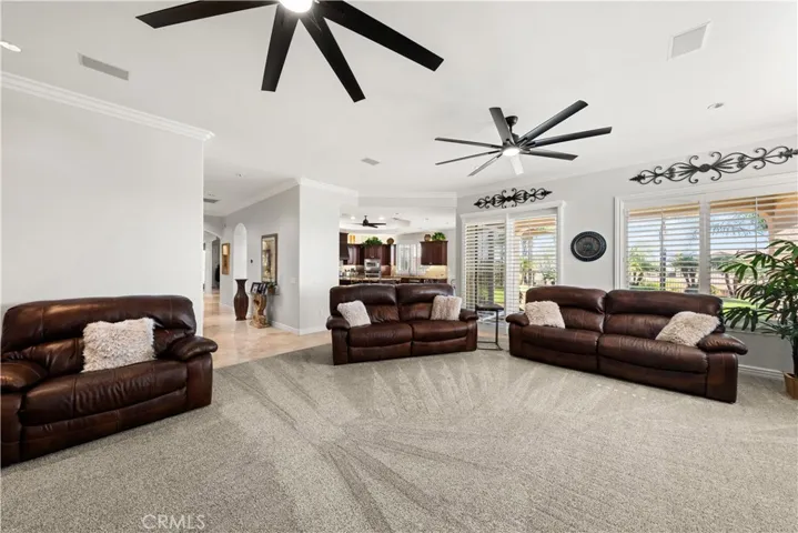 Family Room Showing Large Dual Ceiling Fans and the Spacious Layout.