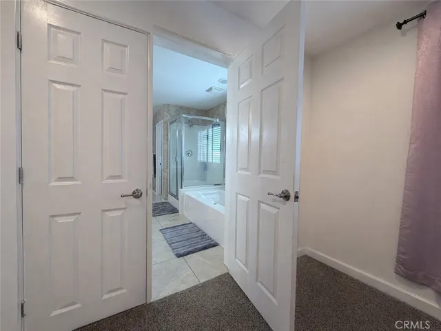 Door between primary ensuite bathroom and nursery/office/work out room