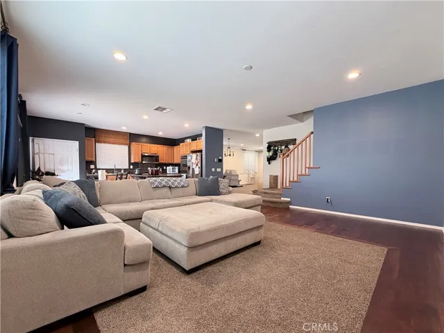 View of family room, kitchen and peek a boo of the formal dining room/living room beyond