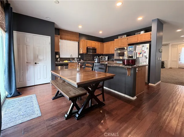 View of kitchen from the family room. Note the large pantry on left and sliding glass doors to backyard