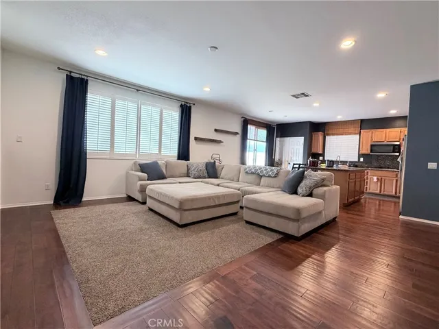 View of family room with kitchen behind