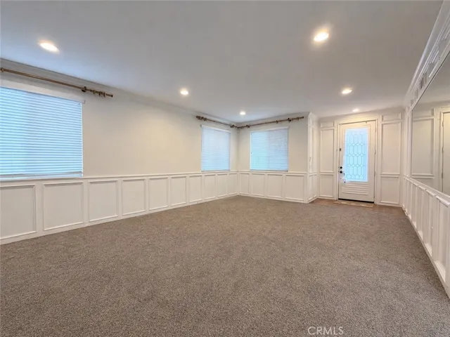 View from family room into living room/formal dining room. Beautiful wainscotting for this formal space.
