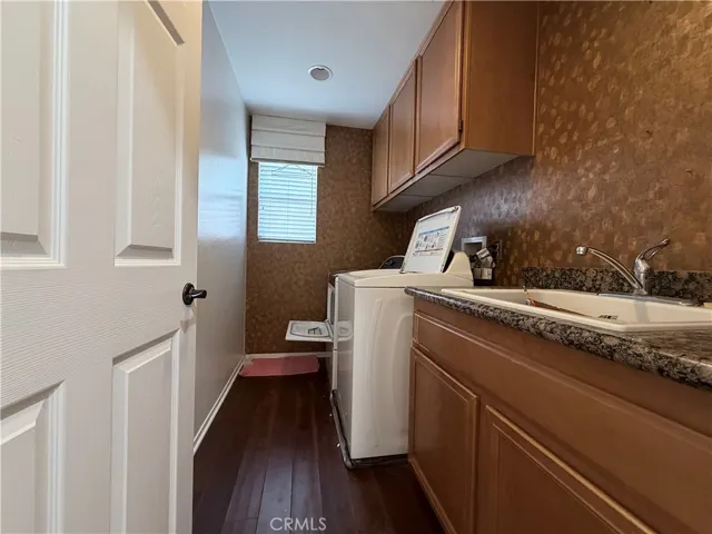 Upstairs laundry room with utility sink

