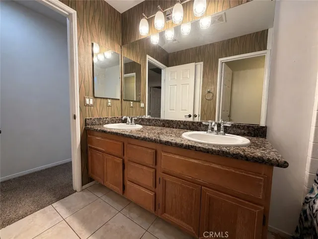 Upstairs full bathroom with dual sinks. Tub shower and toilet with own door not pictured