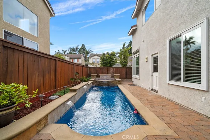 Backyard Oasis with Pool, Spa, Multiple Water Features, Interlocking Paver Decking