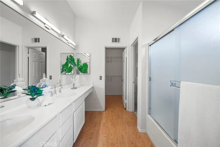 Luxurious Primary Bathroom with Tub/Shower Combo, Dual Sinks, Vanity, and Huge Walk-In Closet