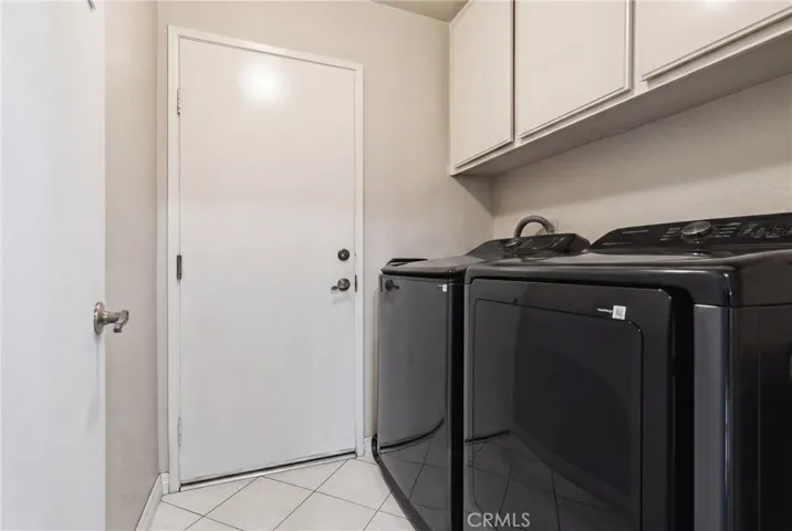 laundry room with two closed off doors from the garage to the house.