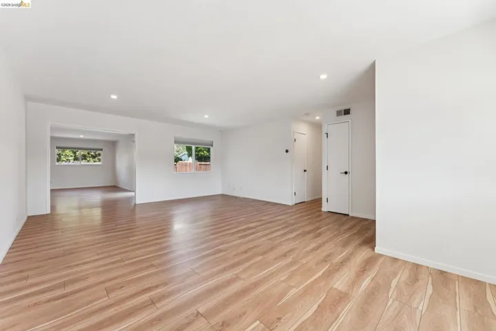 Empty room featuring light wood finished floors and recessed lighting