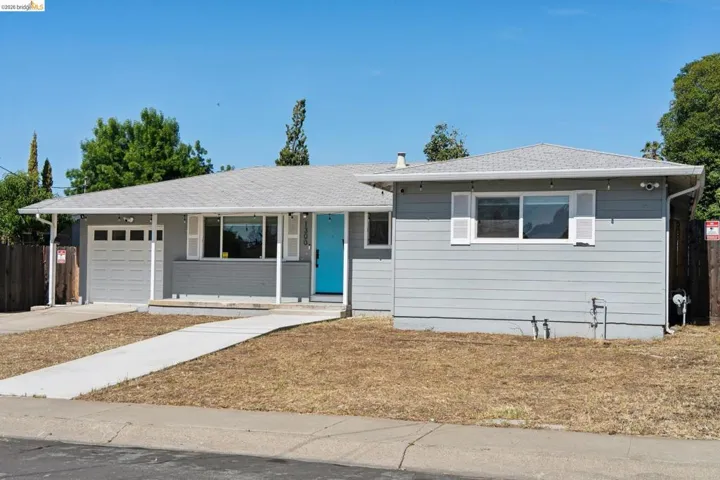 Ranch-style house with a garage, concrete driveway, and roof with shingles