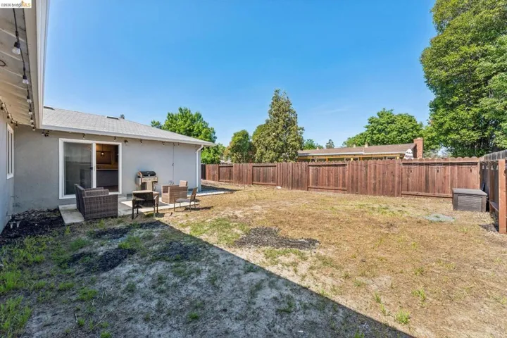 Fenced backyard featuring a patio