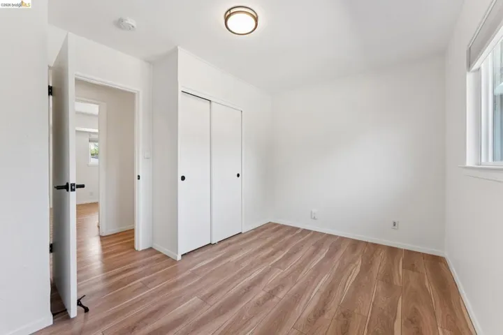 Unfurnished bedroom with light wood-style flooring and a closet