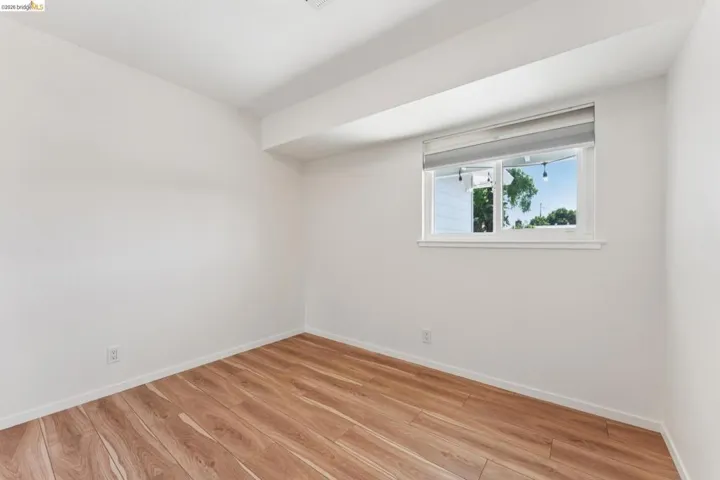 Spare room with light wood-style flooring and baseboards