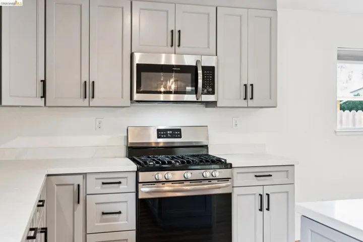 Kitchen featuring stainless steel appliances and light stone countertops