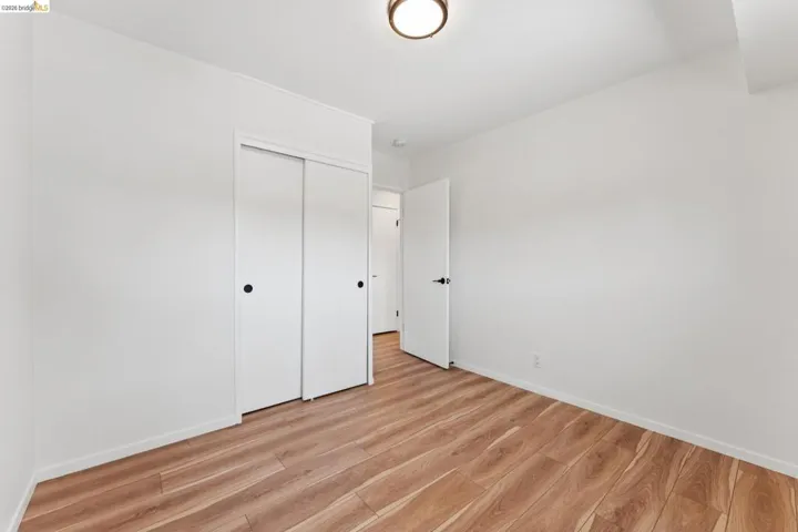 Unfurnished bedroom with light wood-type flooring and a closet