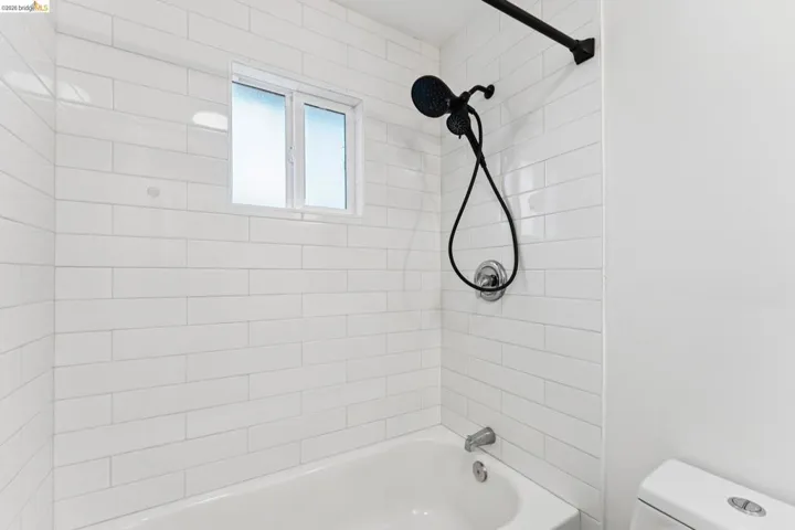 Full bath with toilet and tub / shower combination