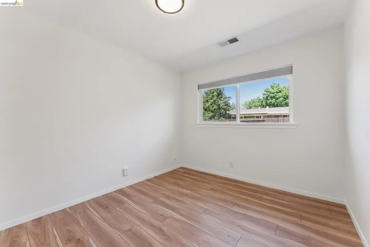 Empty room featuring light wood-style flooring and baseboards