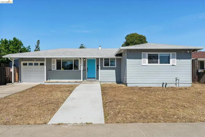 Single story home featuring a garage and concrete driveway