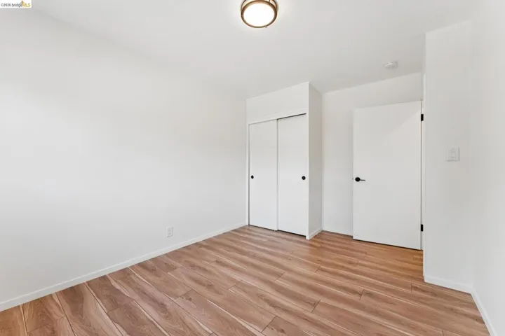 Unfurnished bedroom featuring light wood-style flooring and a closet