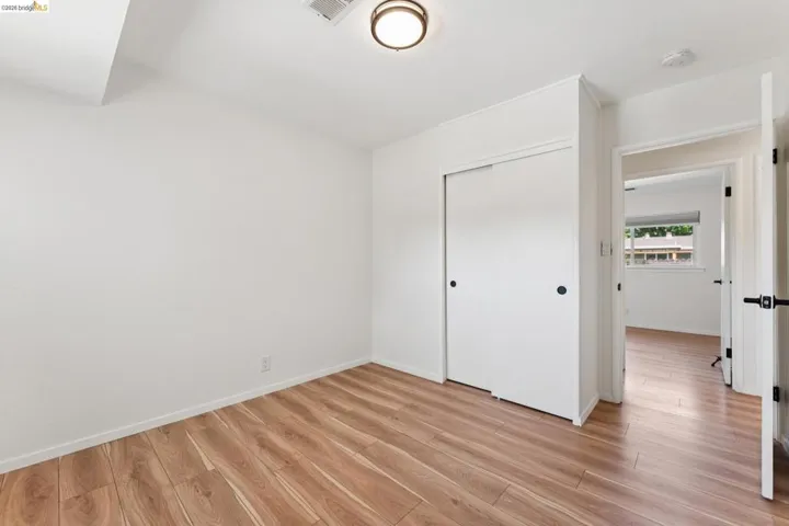 Unfurnished bedroom with light wood-style floors and a closet