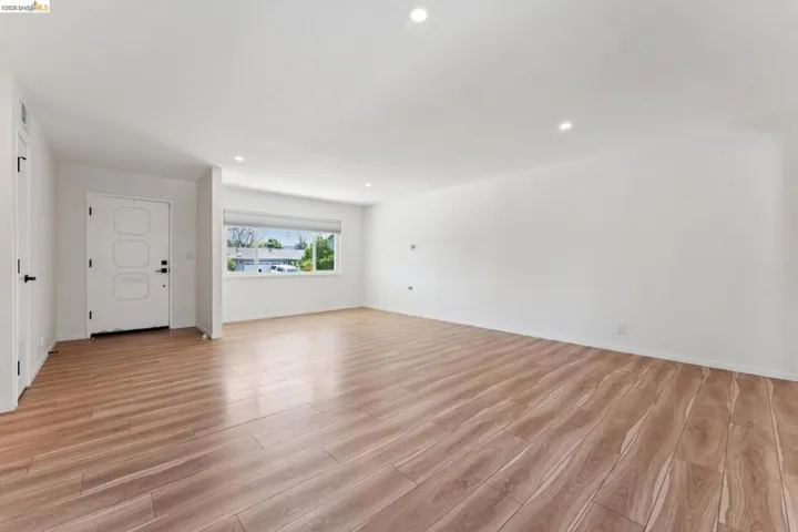 Unfurnished living room featuring light wood-style floors and recessed lighting