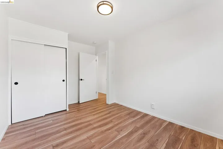 Unfurnished bedroom with light wood-style flooring and a closet