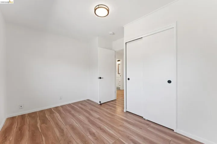 Unfurnished bedroom with light wood-style flooring and a closet