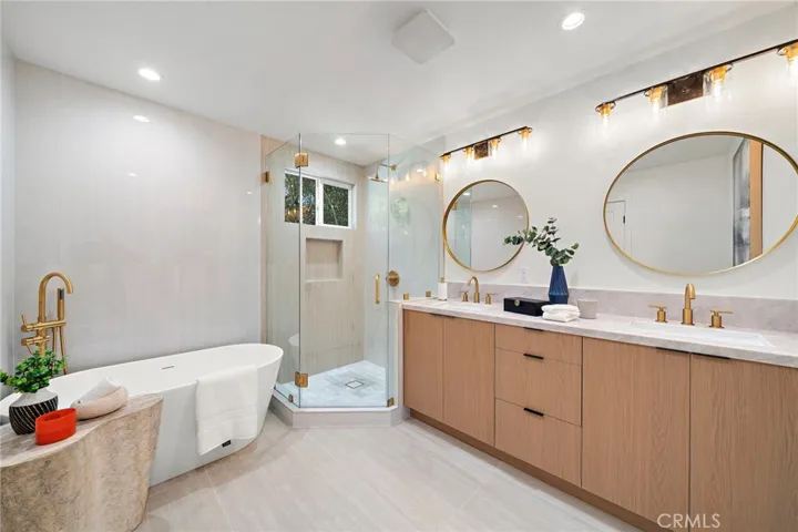 Spa inspired primary bath with freestanding tub and glass enclosed shower