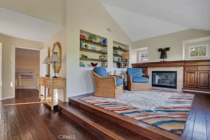 Primary bedroom sitting area with fireplace.