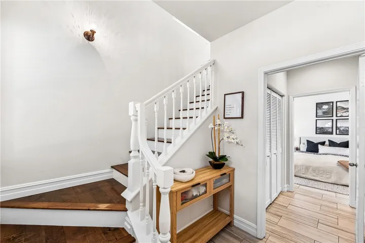 Entry, take the stairs to the main floor, or head straight to indoor laundry on the left and the primary suite. Direct garage access to the foyer on the right.