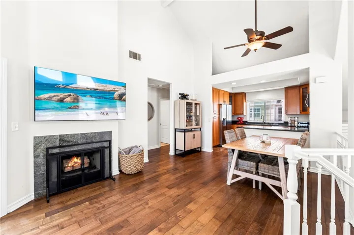 View looking towards dining and kitchen from top of stairs. Hallway leads to 2 upper bedrooms separated by full bath.
