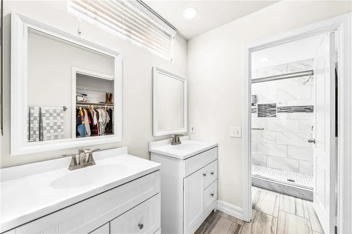 Dual vanities make busy mornings a breeze; notice the reflection of the oversize walk-in in the mirror.
