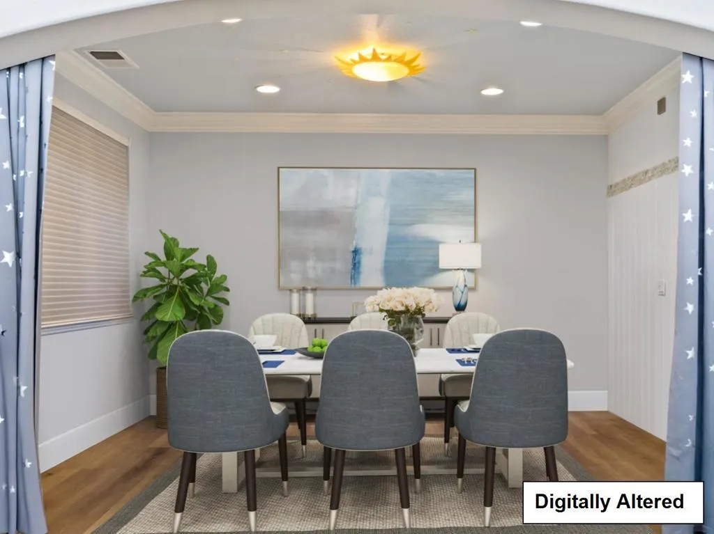 DIGITALLY ALTERED -it is staged so a buyer can see how it looks with Furniture in the formal dining