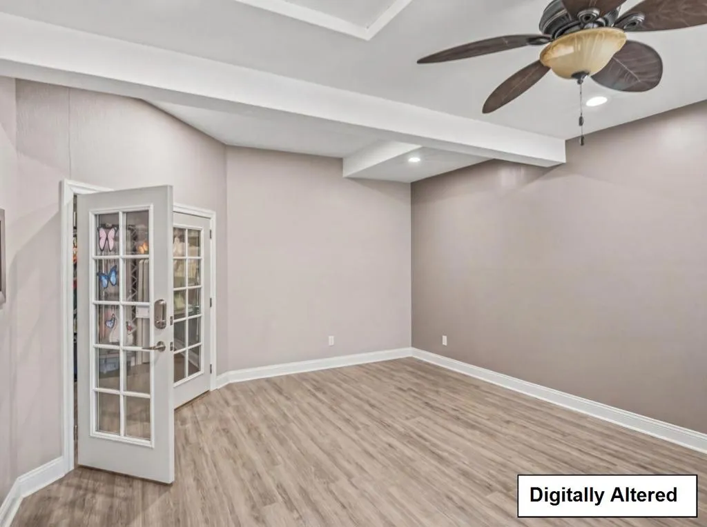 DIGITALLY ALTERED SHOWING vacant and decluttered office in garage