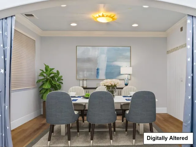 DIGITALLY ALTERED -it is staged so a buyer can see how it looks with Furniture in the formal dining