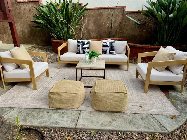 Lovely backyard seating area (brick is under the rug)