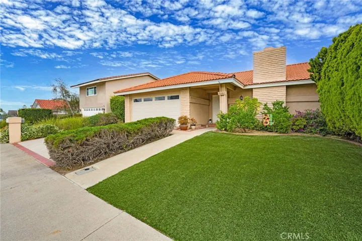 Expansive front yard complimented by astroturf for easy maintenance.