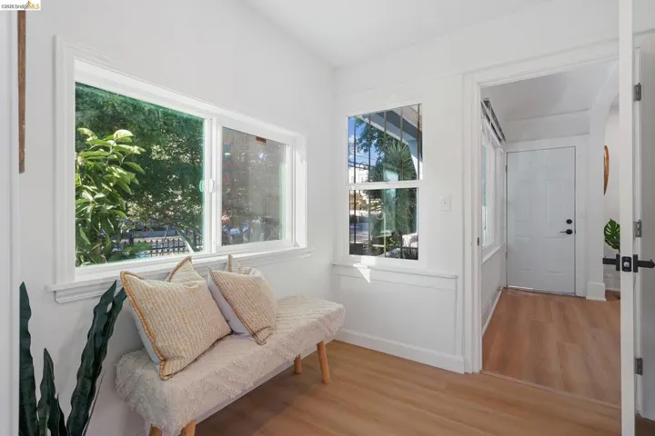 Bright entryway featuring light wood-finish flooring and white trim
