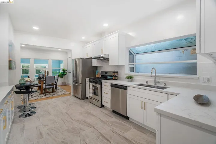 Modern kitchen with light-toned tile flooring and white cabinetry