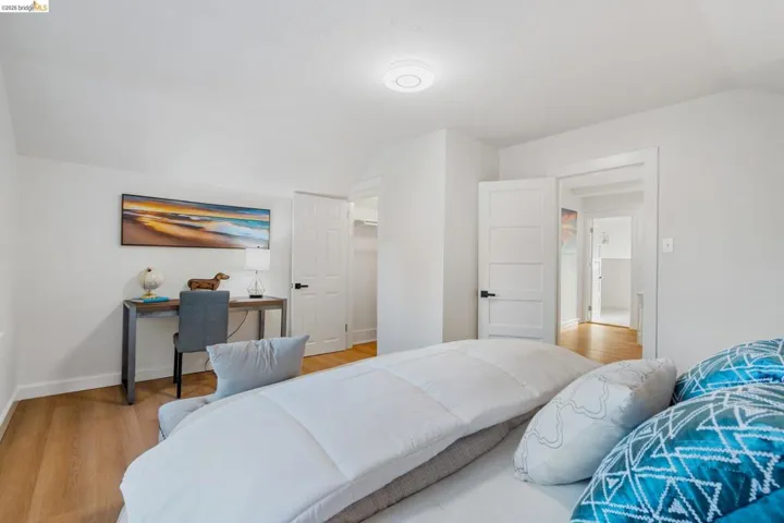 Light wood-finish flooring throughout, complemented by white walls and trim