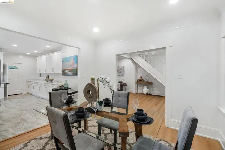 Dining area featuring wood-finish flooring, recessed lighting, and crown molding