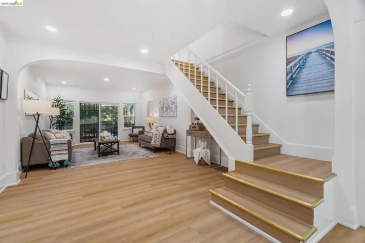 Open concept living area with wood-finish flooring